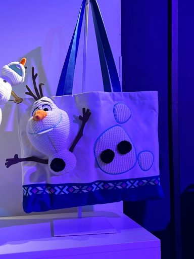 Tote bag featuring Olaf the snowman with arms outstretched and playful designs.