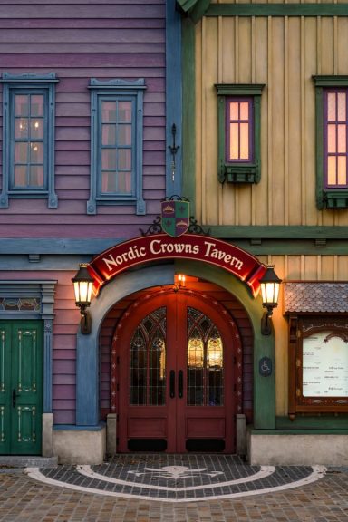 Colourful building facade featuring arched entrance and decorative signage.