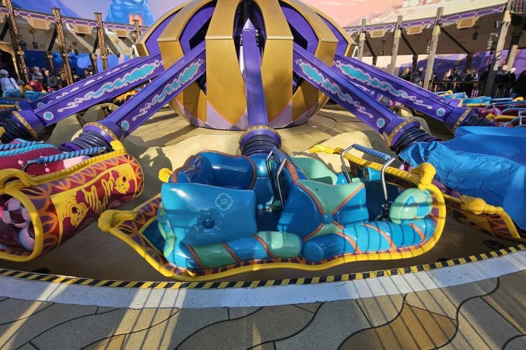 Image of one of the turquoise and green carpet ride vehicles