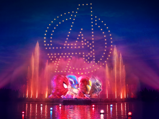 A vibrant water fountain display with an Avengers logo backdrop.