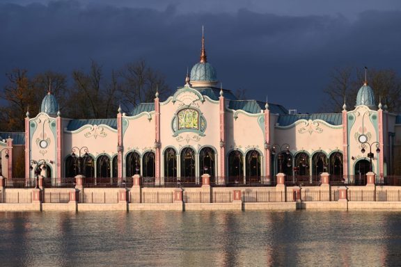 The restaurant, by the serene lake, featuring decorative domes and vibrant colours.